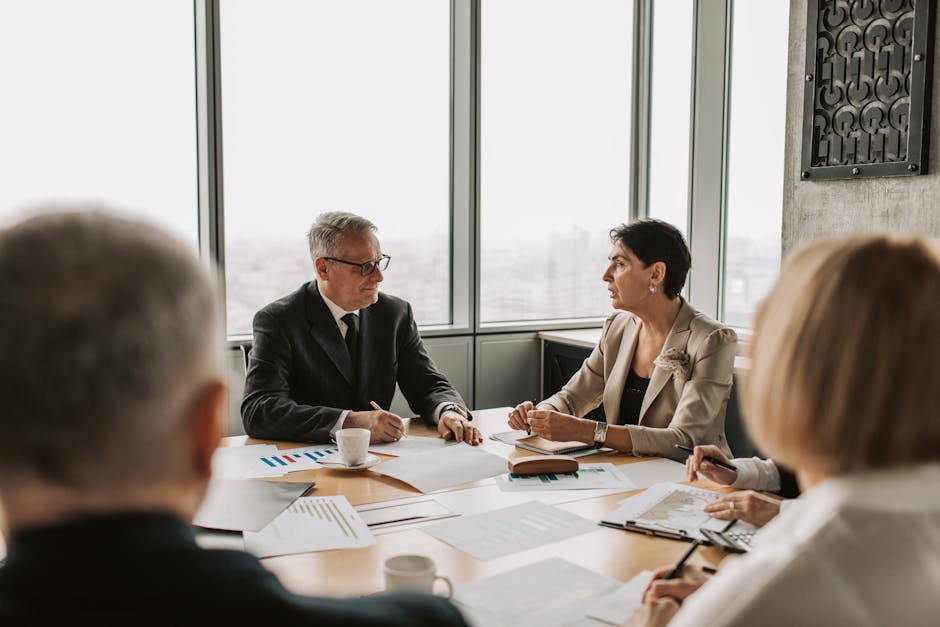 Business professionals engaged in a strategic meeting in a modern office setting with natural light